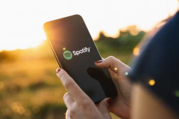BERLIN, GERMANY JULY 2019: Woman holding a iPhone Xs opening spotify app, Spotify is a music service that offers legal streaming music.- Stock Photo or Stock Video of rcfotostock | RC Photo Stock