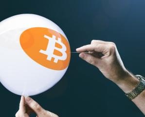bitcoins - bit coin BTC the new virtual money on balloon with needle in hand before burst- Stock Photo or Stock Video of rcfotostock | RC Photo Stock