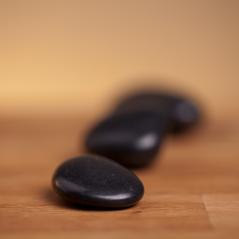 black stones on wood background- Stock Photo or Stock Video of rcfotostock | RC Photo Stock