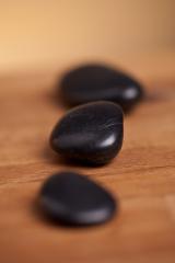 black stones on wood background- Stock Photo or Stock Video of rcfotostock | RC Photo Stock