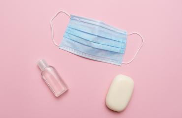 Blue medical mask, soap and hand sanitizer on pink background. Concept of protection against corona virus covid 19 pandemic.- Stock Photo or Stock Video of rcfotostock | RC-Photo-Stock