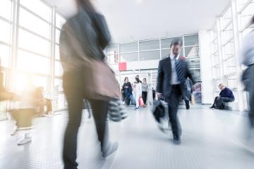 Blurred business people at a trade fair entrance- Stock Photo or Stock Video of rcfotostock | RC Photo Stock