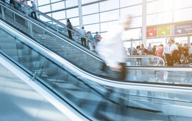 Blurred people using a escalator on a trade dair : Stock Photo or Stock Video Download rcfotostock photos, images and assets rcfotostock | RC Photo Stock.: