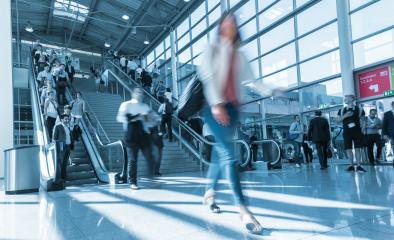 Blurred trade fair visitor using a skywalk/staircase- Stock Photo or Stock Video of rcfotostock | RC Photo Stock