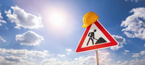 building construction site Street DANGER Sign, with yellow helmet against blue cloudy sky. Under construction concept image : Stock Photo or Stock Video Download rcfotostock photos, images and assets rcfotostock | RC Photo Stock.: