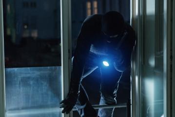 Burglar breaking and entering a house window at night- Stock Photo or Stock Video of rcfotostock | RC Photo Stock