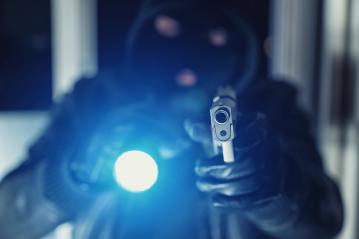 Burglar or a thief holding a gun with flashlight in a house- Stock Photo or Stock Video of rcfotostock | RC Photo Stock