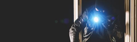 Burglar with crowbar and flashlight in the window of a house, with copy space, banner size- Stock Photo or Stock Video of rcfotostock | RC-Photo-Stock
