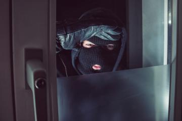 Burglar with looking through the window at night- Stock Photo or Stock Video of rcfotostock | RC-Photo-Stock