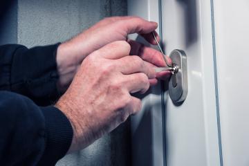 Burglars crack the front door with lock picking : Stock Photo or Stock Video Download rcfotostock photos, images and assets rcfotostock | RC-Photo-Stock.: