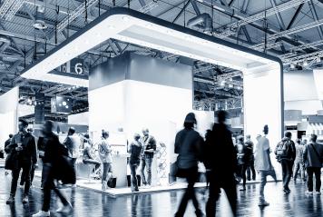 business people walking between trade show booth, with copy space for individual text- Stock Photo or Stock Video of rcfotostock | RC Photo Stock