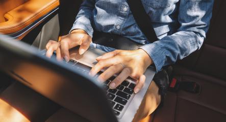 businesswoman typing on her laptop at the backseat in luxery car limousine. - Stock Photo or Stock Video of rcfotostock | RC Photo Stock
