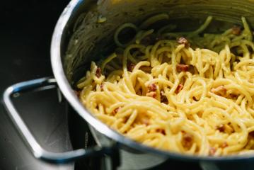 Carbonara pasta, spaghetti with pancetta, egg, hard parmesan cheese and cream sauce in a silver pot : Stock Photo or Stock Video Download rcfotostock photos, images and assets rcfotostock | RC Photo Stock.: