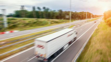 Cargo truck with cargo trailer driving on a highway. White Truck delivers goods in early hours of the Morning - very low angle drive thru close up shot.- Stock Photo or Stock Video of rcfotostock | RC-Photo-Stock