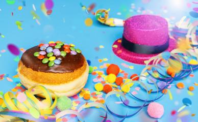 Carnival donut from Germany with icing chocolate sugar on a blue surface with confetti and streamers on it - background for a carnival party or parties : Stock Photo or Stock Video Download rcfotostock photos, images and assets rcfotostock | RC Photo Stock.: