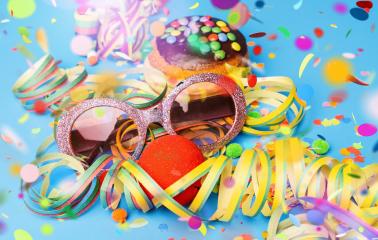 Carnival sunglasses with donut from Germany with icing chocolate sugar on a blue surface with confetti and streamers on it - background for a carnival party or parties : Stock Photo or Stock Video Download rcfotostock photos, images and assets rcfotostock | RC Photo Stock.: