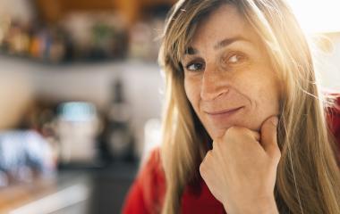 Close up  Woman Standing in the kitchen with Hand on the Chin. Captured her While Looking at the Camera indoors with copy space- Stock Photo or Stock Video of rcfotostock | RC Photo Stock