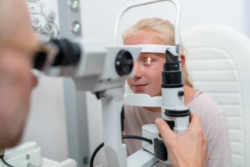 Close up shot of a girl checking vision with tonometer at eye clinic- Stock Photo or Stock Video of rcfotostock | RC Photo Stock