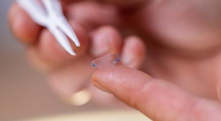 Close-up of a contact lens on a fingertip with a tweezer in the - Stock Photo or Stock Video of rcfotostock | RC Photo Stock
