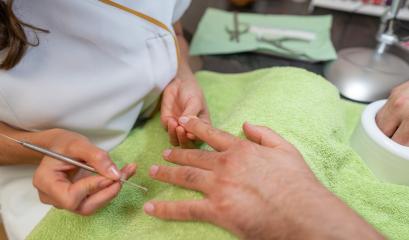 Close-up of a manicure with a manicurist cleaning under a client. body care spa treatment concept image- Stock Photo or Stock Video of rcfotostock | RC Photo Stock