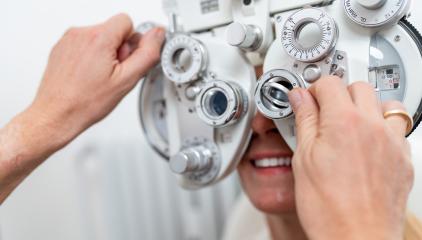 Close-up of a optician adjusting a phoropter for a female patien- Stock Photo or Stock Video of rcfotostock | RC Photo Stock