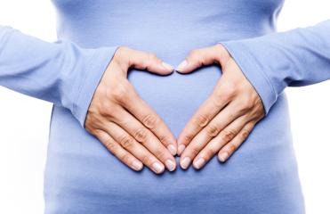 Close-up of a woman in a blue shirt forming a heart shape with her hands on her belly, symbolizing love, care, pregnancy, and motherhood
 : Stock Photo or Stock Video Download rcfotostock photos, images and assets rcfotostock | RC Photo Stock.: