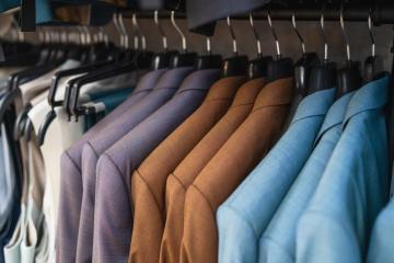 Close-up of assorted suits on hangers, focused on texture and colors at a men's clothing store- Stock Photo or Stock Video of rcfotostock | RC Photo Stock