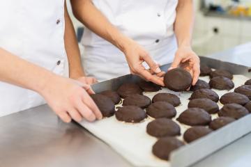 Close-up of bakers handling chocolate-covered gingerbreads on a tray in a bakery, carefully inspecting the treats in a professional baking environment : Stock Photo or Stock Video Download rcfotostock photos, images and assets rcfotostock | RC Photo Stock.: