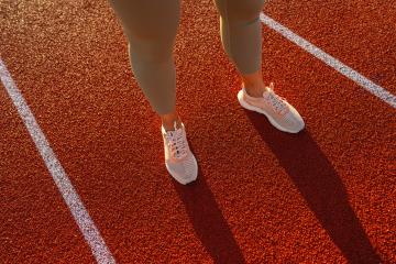 Close-up of female athlete's legs on starting line of running track- Stock Photo or Stock Video of rcfotostock | RC Photo Stock