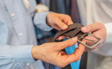 Close-up of hands holding a black leather belt with a silver buckle in a wedding store : Stock Photo or Stock Video Download rcfotostock photos, images and assets rcfotostock | RC Photo Stock.: