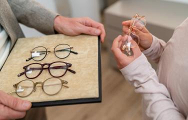 Close-up of hands presenting various eyeglasses on a tray in a o- Stock Photo or Stock Video of rcfotostock | RC Photo Stock