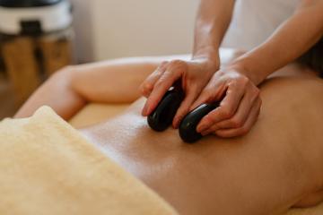 Close-up of hot stone massage therapy on a bare back with therapist’s hands at a beauty salon or hotel : Stock Photo or Stock Video Download rcfotostock photos, images and assets rcfotostock | RC Photo Stock.: