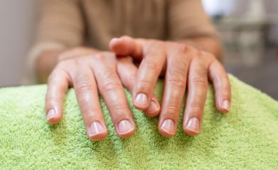 Close-up of well-manicured hands from a man resting on a green towel. body care spa treatment concept image- Stock Photo or Stock Video of rcfotostock | RC Photo Stock