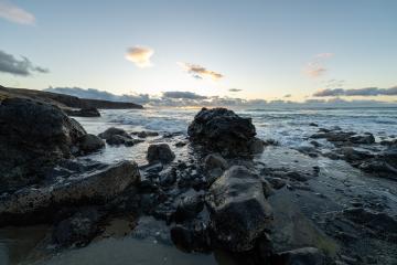 Coastal landscape at sunset with waves crashing on rocky shoreline under a cloudy sky at fuerteventura : Stock Photo or Stock Video Download rcfotostock photos, images and assets rcfotostock | RC Photo Stock.: