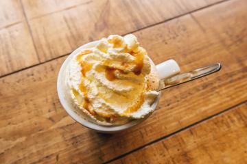 Cold coffee drink frappe (frappuccino), with whipped cream and caramel syrup, with spoon on a wooden table- Stock Photo or Stock Video of rcfotostock | RC-Photo-Stock