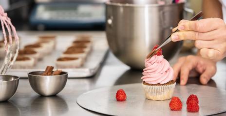 confectioner hand draped pieces of chocolate on a muffin topping with tweezers in a pastry bakery  : Stock Photo or Stock Video Download rcfotostock photos, images and assets rcfotostock | RC Photo Stock.:
