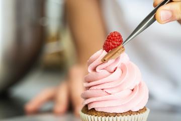 confectioner hand draped pieces of chocolate on a muffin topping with tweezers in a pastry bakery  : Stock Photo or Stock Video Download rcfotostock photos, images and assets rcfotostock | RC Photo Stock.: