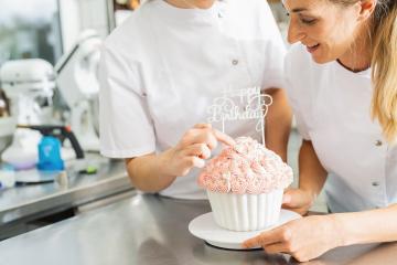 confectioners decorating big Birthday cake muffin with candies at pastry bakery : Stock Photo or Stock Video Download rcfotostock photos, images and assets rcfotostock | RC Photo Stock.: