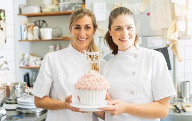 confectioners smiling proudly and holding big Birthday cake muffin with candies at pastry bakery : Stock Photo or Stock Video Download rcfotostock photos, images and assets rcfotostock | RC Photo Stock.: