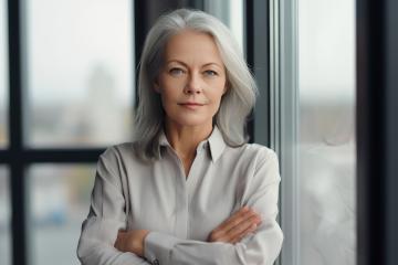 Confident mature woman with silver hair stands by large windows- Stock Photo or Stock Video of rcfotostock | RC Photo Stock