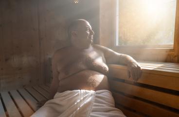 Content man relaxing in a finnish sauna, with sunlight streaming through the window. : Stock Photo or Stock Video Download rcfotostock photos, images and assets rcfotostock | RC Photo Stock.: