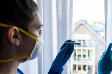 corona COVID-19 infection person looks at the clinical thermometer in quarantine - stay at home  : Stock Photo or Stock Video Download rcfotostock photos, images and assets rcfotostock | RC Photo Stock.: