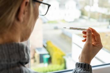 corona COVID-19 infection woman looks at the clinical thermometer in quarantine - stay at home : Stock Photo or Stock Video Download rcfotostock photos, images and assets rcfotostock | RC Photo Stock.: