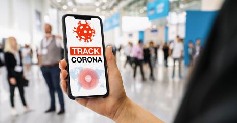 coronavirus tracker app on a mobile smartphone. Close up of woman tracking crowd of people in a smartphone screen application. Hand holding smart device. Mockup website. covid-19 corona virus tracker- Stock Photo or Stock Video of rcfotostock | RC Photo Stock