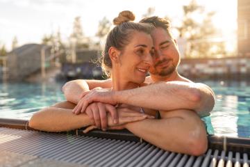 Couple embracing in a pool at sunset, woman smiling and leaning - Stock Photo or Stock Video of rcfotostock | RC Photo Stock