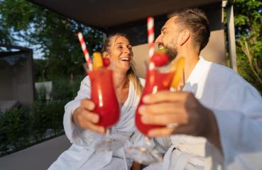 Couple in white robes toasting with red cocktails outdoors at spa resort : Stock Photo or Stock Video Download rcfotostock photos, images and assets rcfotostock | RC Photo Stock.: