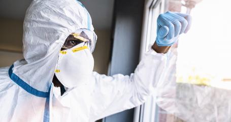 Covid-19 coronavirus epidemic overloads caregiver in protective clothing leans against the window- Stock Photo or Stock Video of rcfotostock | RC-Photo-Stock