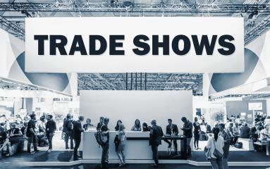 Crowd of people at a trade show booth with a banner and the text Trade Shows.- Stock Photo or Stock Video of rcfotostock | RC-Photo-Stock
