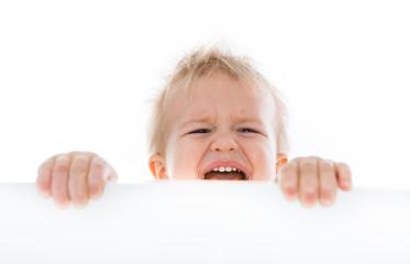 Crying baby holding onto a white surface with a clean white background : Stock Photo or Stock Video Download rcfotostock photos, images and assets rcfotostock | RC Photo Stock.: