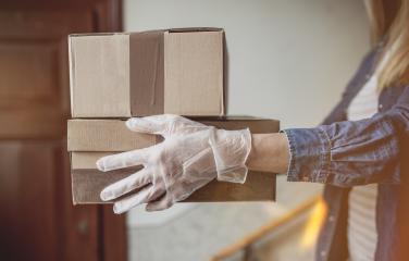 Delivery services courier during the Coronavirus (COVID-19) pandemic, close-up of cardboard box holding by a courier wearing  : Stock Photo or Stock Video Download rcfotostock photos, images and assets rcfotostock | RC Photo Stock.: